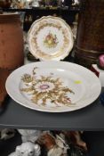A vintage Kaiser West German Silberdistel pattern plate decorated with floral designs on a white
