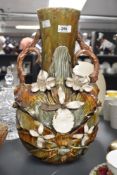An Art Nouveau style ceramic vase of baluster form, decorated with flowers, foliage and having