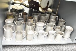 A quantity of pewter tankards