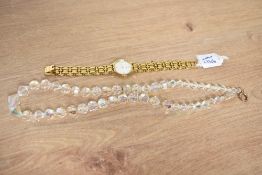 A Tissot wristwatch, the white dial having Roman and dot numerals, on a gold tone stainless steel