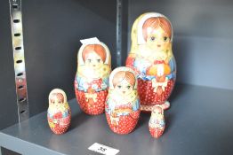 A nest of 5 hand painted wooden dolls, h15.5cm