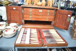 An early 20th century mahogany canteen, the moulded rectangular top above two panelled doors