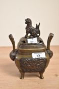A Chinese metal censer/incense burner having Fo Dog finial and stylized handles, h18cm