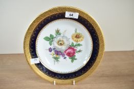 A porcelain Limoges plate hand painted with floral patterns, w23.5cm