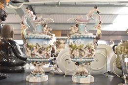 A Meissen style porcelain ewer having elaborate display of playing cherubs and mythological figures,