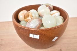 A vintage teak fruit bowl, w26cm, sold together with 25 green onyx eggs, h7cm,