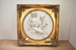 A resin/alabaster plaque depicting mother with child, w40cm