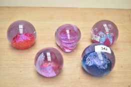 A Caithness 'Checkpoint' glass paperweight, h7cm, sold together with 4 others