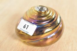 A John Ditchfield iridescent glass paperweight of swirl form, signed to base, h6cm