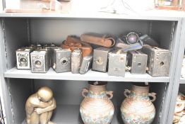 A quantity of vintage cameras and cases, to include a Brownie camera, a Kodak camera and a Hawkeye