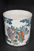 A Chinese / oriental brush pot of cylindrical form decorated with figural story scenes, h21cm