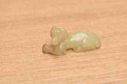 A Chinese carved jade or hardstone pendant / amulet in the form of a dog, h5.5cm