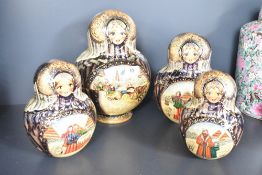 A nest of 25 hand painted wooden dolls, largest h25cm