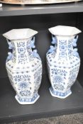 A pair of blue and white porcelain vases of hexagonal baluster form and decorated with floral