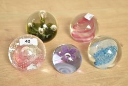 A Caithness 'Pink Champagne' glass paperweight, w8cm, sold together with 4 others