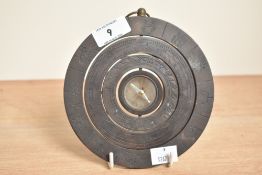 A metal zodiac sphere having a central compass, w15cm