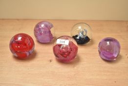 A Caithness 'Quicksilver' glass paperweight, h7cm, sold alongside 4 others