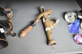A 20th century brass bottle opener for mounting to a table, h31cm