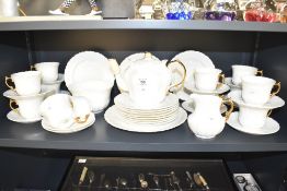 A Aynsley tea service having gilt handles and floral patterns, to include tea pot, cream jug, cups