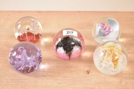 A Caithness 'Maydance' glass paperweight, h7cm, sold together with 4 other glass paperweights