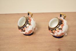 A pair of Royal Crown Derby 'Imari' pattern pots of circular form raised on a footed base, h7.5cm