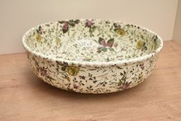 A Harebell ceramic bowl decorated with floral and fruit designs, impressed and painted marks to