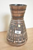A ceramic vase of baluster form decorated with geometrical patterns, stamped to base 'The