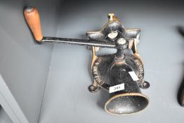 A 20th century cast metal coffee gringer having impressed mark for Sponge & Co Ltd, h27cm