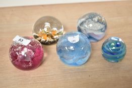 A Caithness 'Debutante' glass paperweight, w8cm, sold alongside 4 others