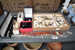 An assortment of costume jewellery, including a gold tone silver paste set necklace, paste set