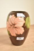 A Moorcroft pottery 'Hibiscus' pattern vase of ovoid form, decorated with floral designs on a washed