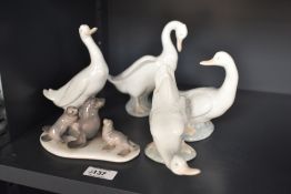 A Lladro porcelain seal family model number 5318 sold alongside group of four Nao by Lladro