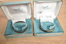 A hinged silver bangle having engraved scroll decoration and concealed clasp, approx 18.6g and