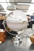 A 20th century chrome mounted globe, mounted through the poles horizontally h42cm