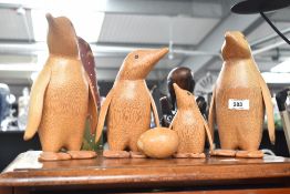 A group of four palm wood duck figures, two large, one medium and one small (12.5cm) and a turned