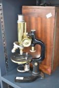 A C. Reichert Wien microscope with brass focus, cases, glass and box
