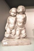 A winged cherub group, 'the Cherubs', patinated resin, on a rectangular plinth, h43cm *purchased