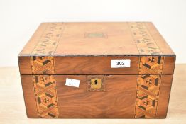 A 19th century jewellery box decorated with geometrical inlay patterns, w30cm