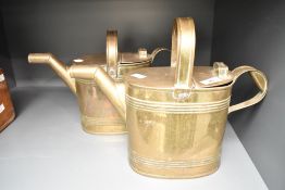 A pair of brass watering cans in the style of Dr. Christopher Dresser, h27.5cm