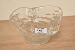 A 20th century clear glass bowl of asymmetrical form having flared edges, w18cm