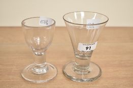 Two 19th century firing glasses, largest h10cm