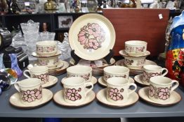 A Kiln Craft ironstone dinner service decorated with pink floral patterns, to include large dinner