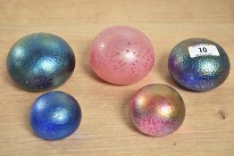 In the style of John Ditchfield - A group of 5 iridescent glass paperweights, largest w6cm x h8cm