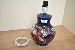 A Moorcroft pottery lamp decorated with floral patterns on a colbert blue ground, h27cm
