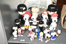 A quantity of snoopy figures largest h20.5cm sold together with Homepride flour shakers a pedestal