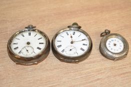 Three silver and white metal open face pocket watches, two having Roman numerals and subsidiary