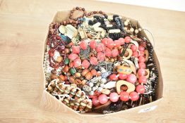 An assortment of costume jewellery, including beaded necklaces, faux pearls, brooches and clip-on