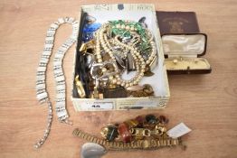 An assortment of costume jewellery, including faux pearls, a tiger's eye set bracelet and