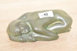 A carved stone sleeping nude, in dark green, bearing signature 'MM' to back.