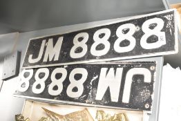 A pair of vintage embossed aluminium vehicle registration plates JM 8888, one with trimmed ends